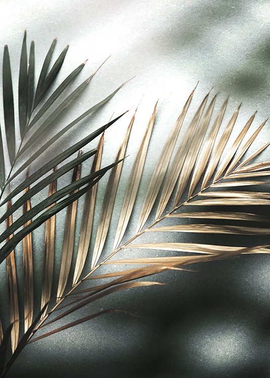  – Foto van twee palmbladeren in goud en groen op een stenen achtergrond