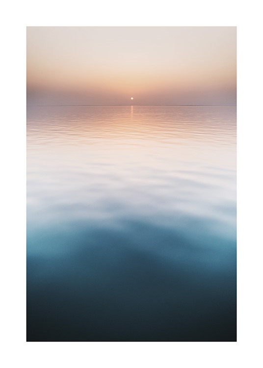 – Foto van een zonsondergang met een kalme oceaan op de voorgrond en een pastelroze hemel